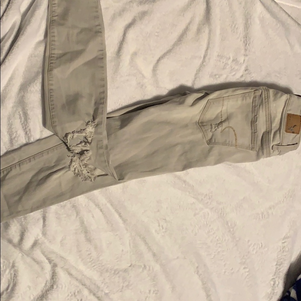 Light gray, ripped skinny jeans.